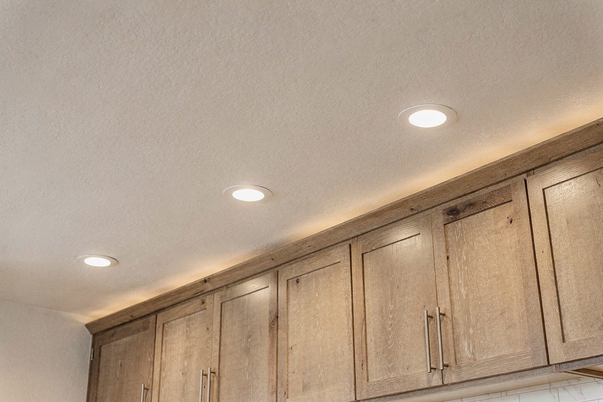 Finished kitchen ceiling with recessed lighting installed